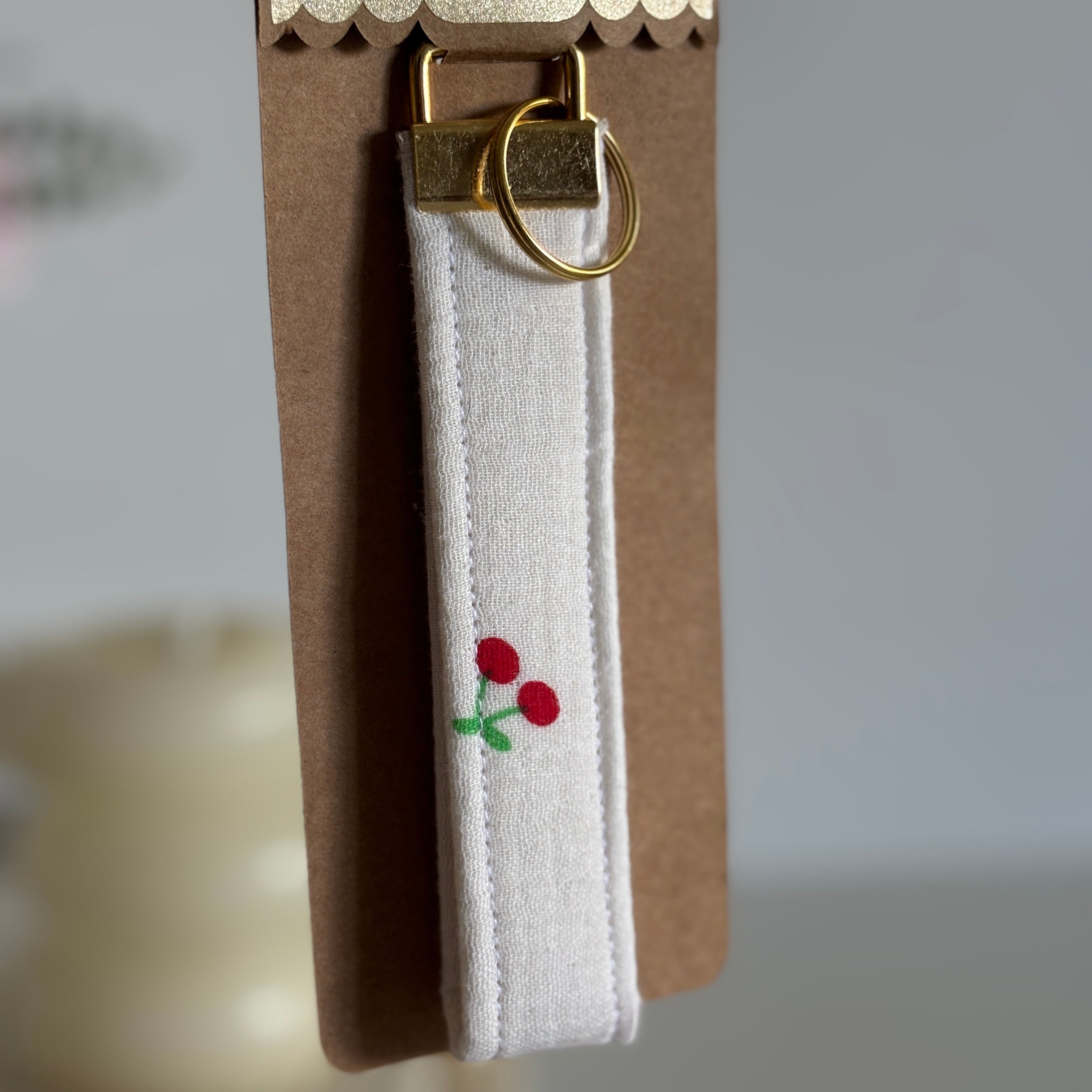 Porte Clé Aurélie - Motif cerise en gaze blanc avec finitions dorées