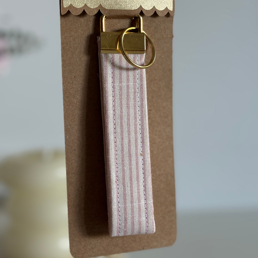 Porte Clé Arcturus - Motif rayé rose et blanc avec finitions dorées